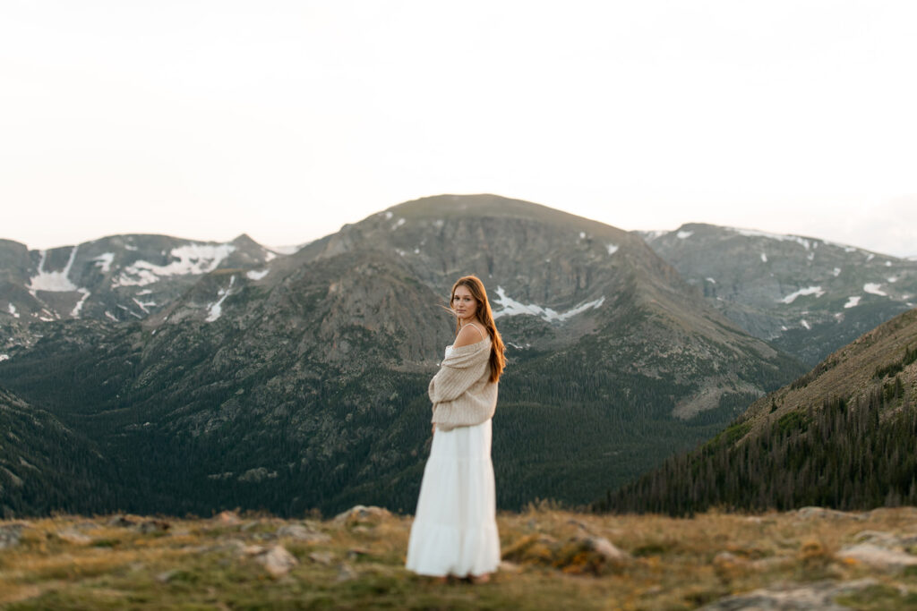 a girl in a cozy sweater at the top of Trail Ridge Road in RMNP
