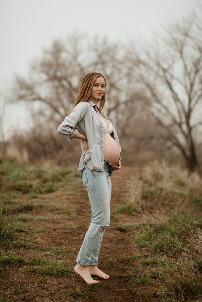 maternity photo with woman wearing all denim and her belly showing