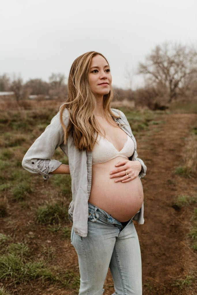 maternity photo with woman wearing all denim and her belly showing