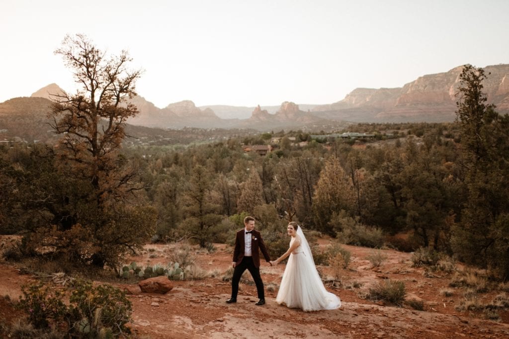 bride and groom in red rocks at sunset in Sedona Arizona