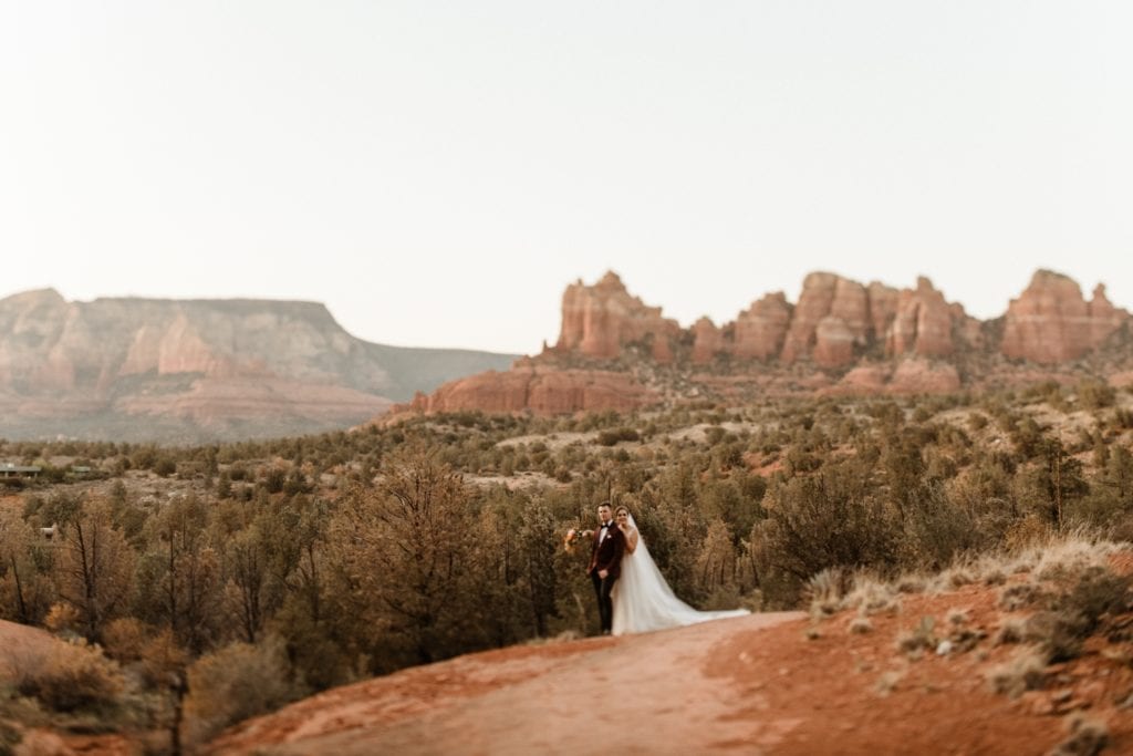 bride and groom in red rocks at sunset in Sedona Arizona