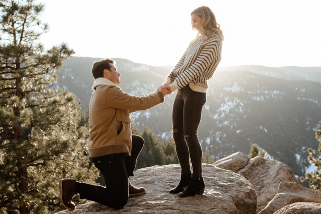 Guy proposes to girl at sunset