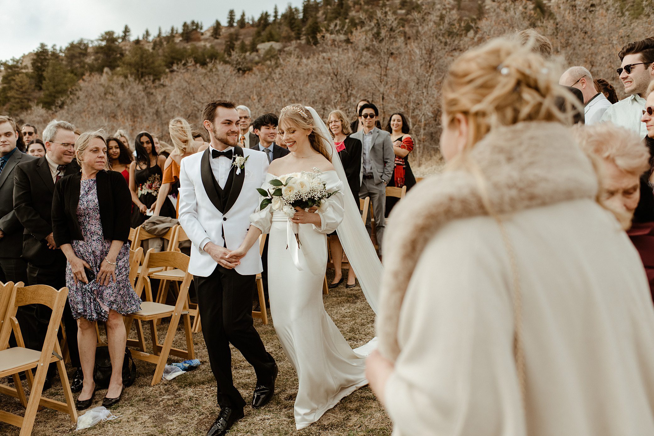 bride and groom walking down the aisle at their lower spruce mountain ranch wedding venue