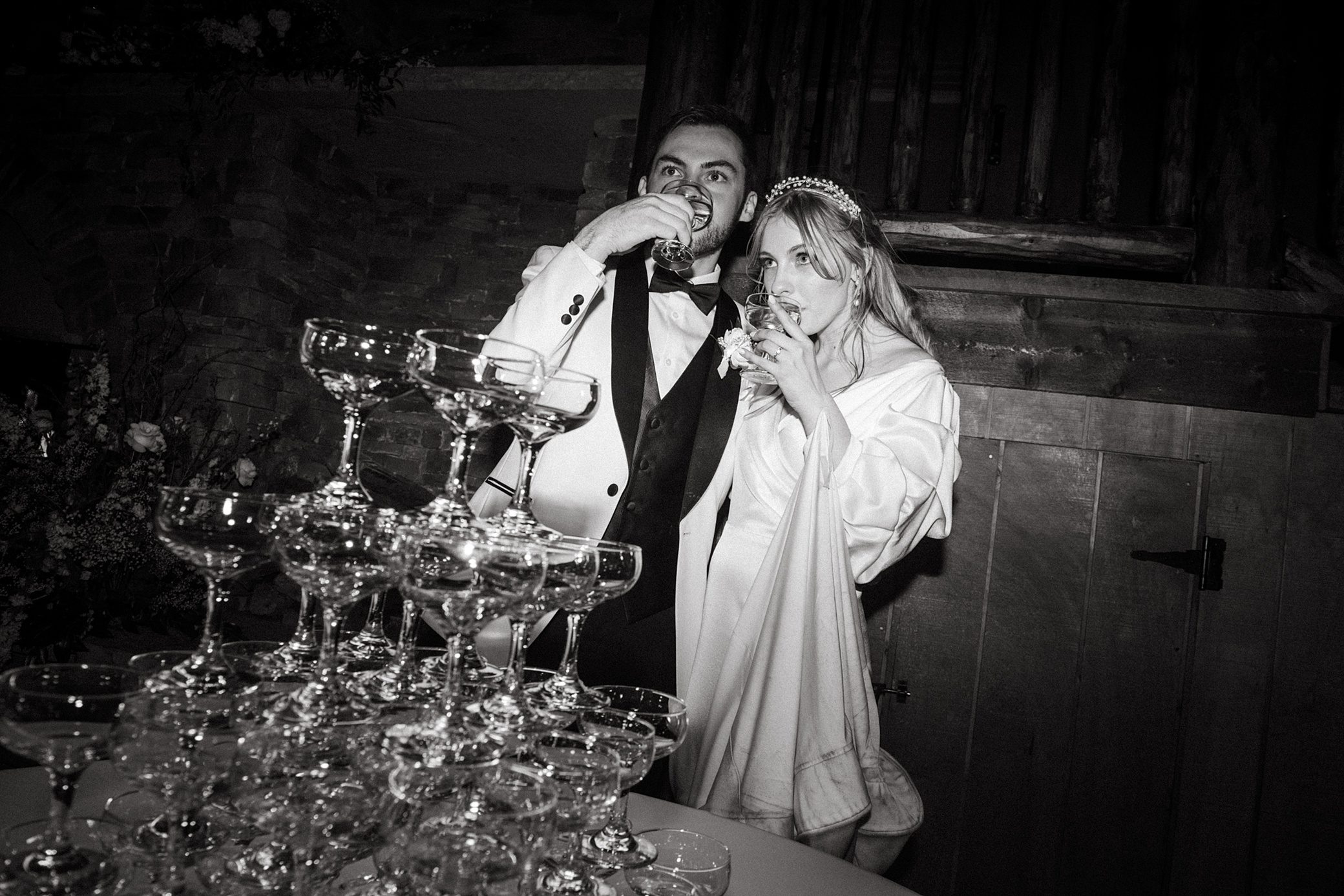 bride and groom enjoy a champagne tower at their wedding reception in Colorado