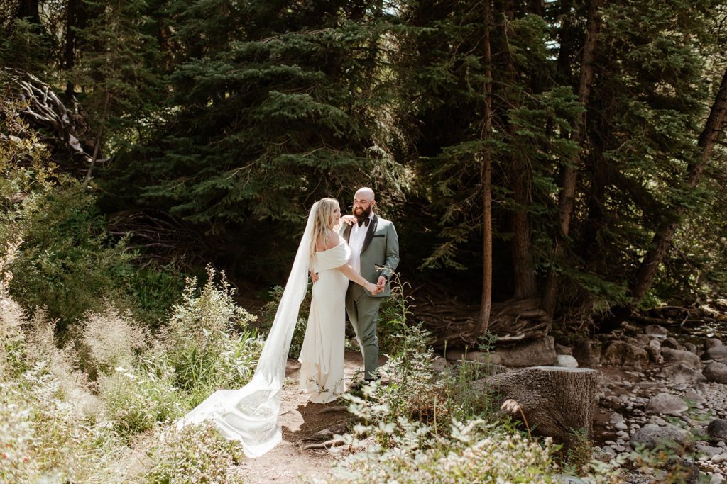 A bride and groom on their wedding day in the woods at the Donovan Pavilion in Vail, Colorado