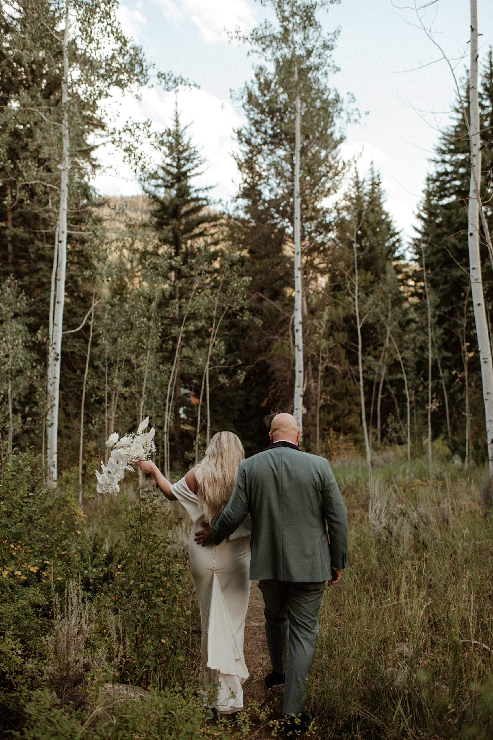 A bride and groom on their wedding day in the woods at the Donovan Pavilion in Vail, Colorado