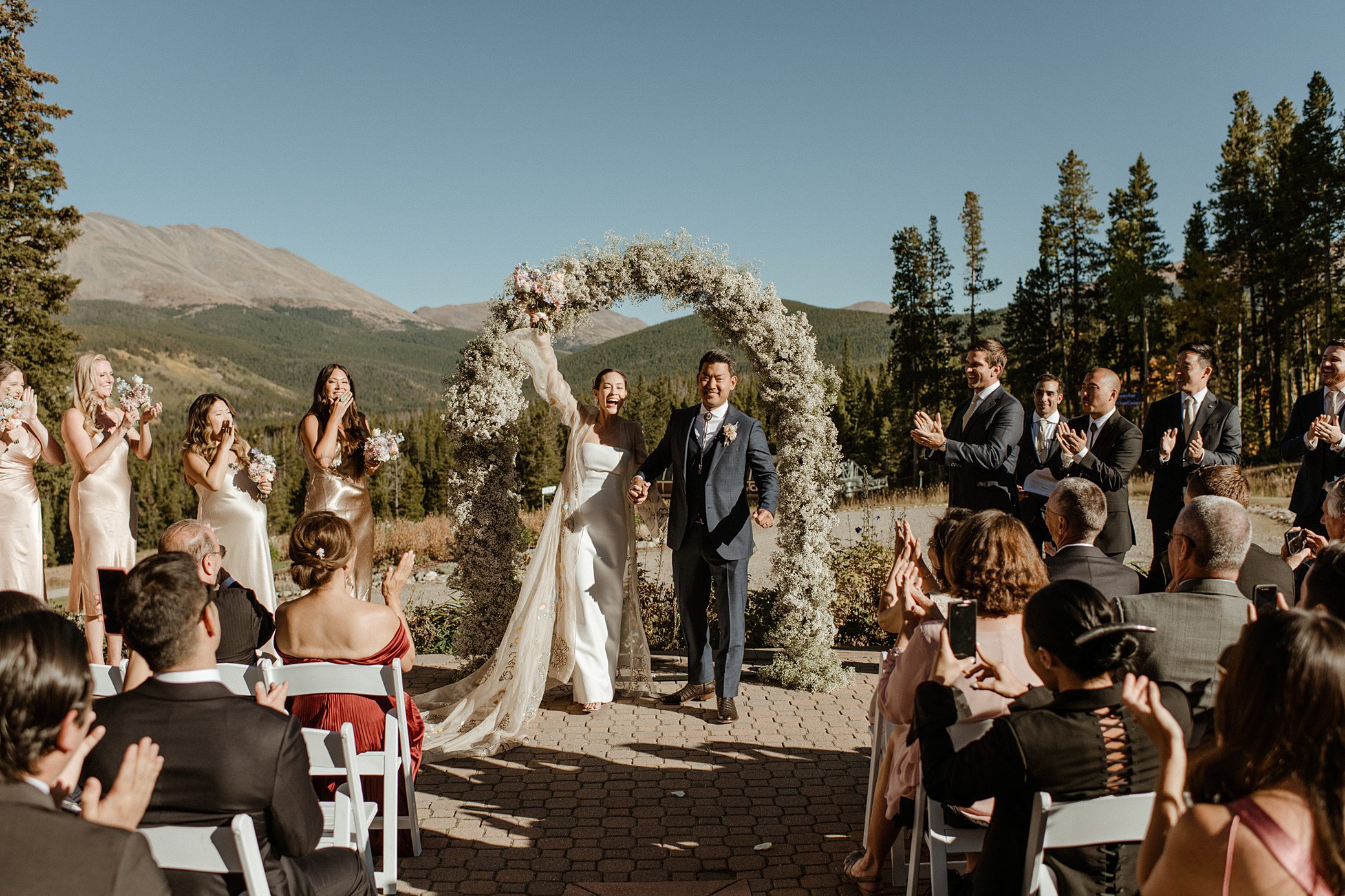 A bride and groom celebrate their wedding ceremony at Ten Mile Station in Breckenridge, Colorado