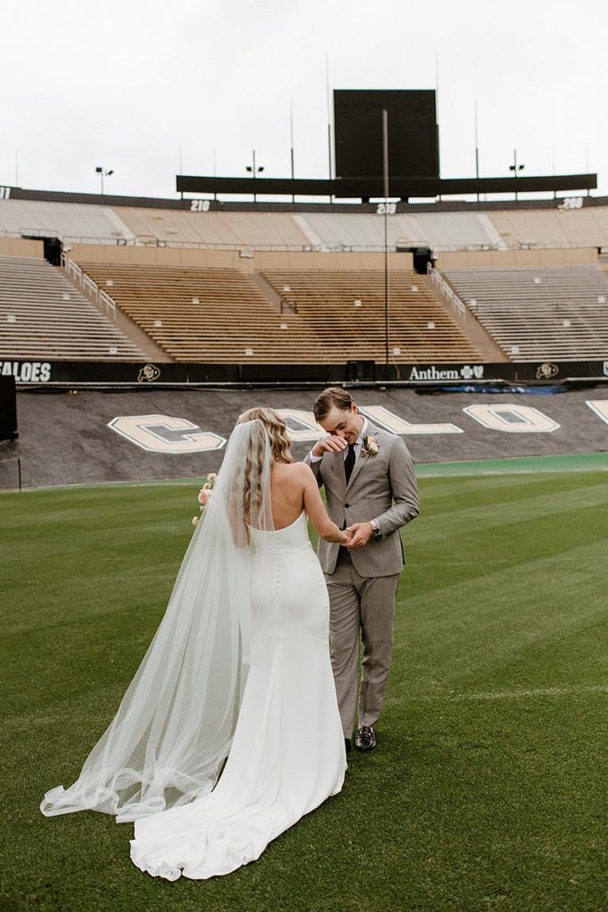 First look on the field at Folsom Field Events Wedding venue in Boulder, Colorado