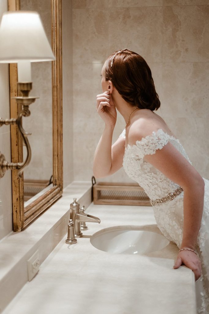 A bride getting ready in the locker rooms of Sanctuary Golf Course