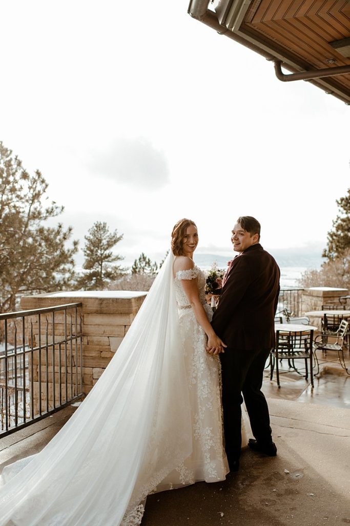 a bride and groom on the terrace of their Sanctuary Golf Course Wedding