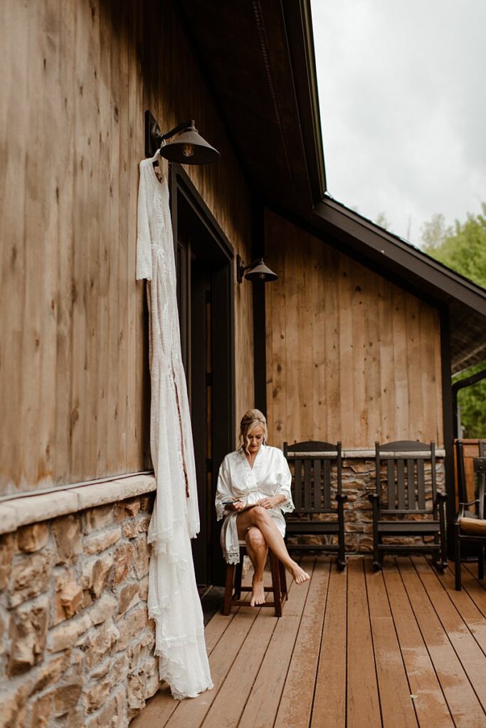 A bride writes her vows on on the deck of her getting ready at the Blackstone Rivers Ranch wedding venue
