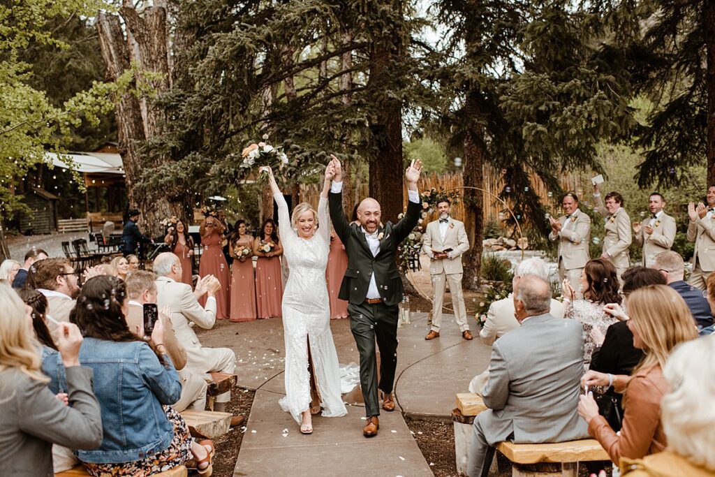 a bride and groom celebrate after wedding ceremony at Blackstone Rivers Ranch in Idaho Springs