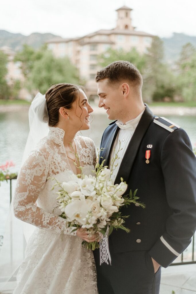 A bride and groom's first look by the lake at the Broadmoor Resort