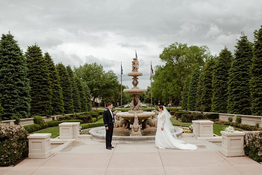 a bride and groom on the front lawn of the Broadmoor Resort and Spa in Colorado Springs