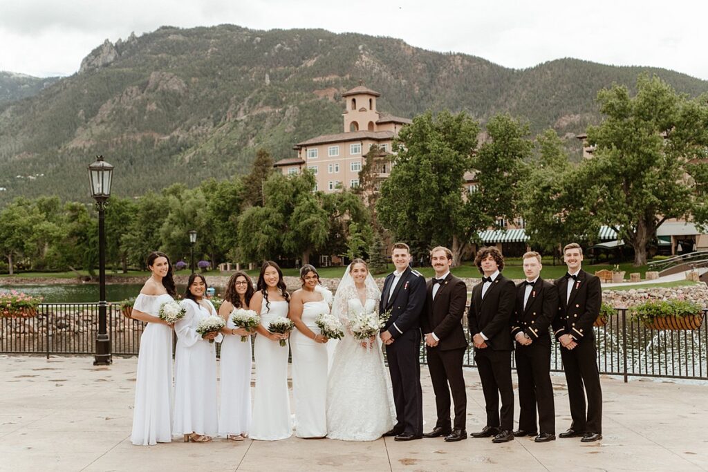 a wedding party celebrating by the lake at the Broadmoor