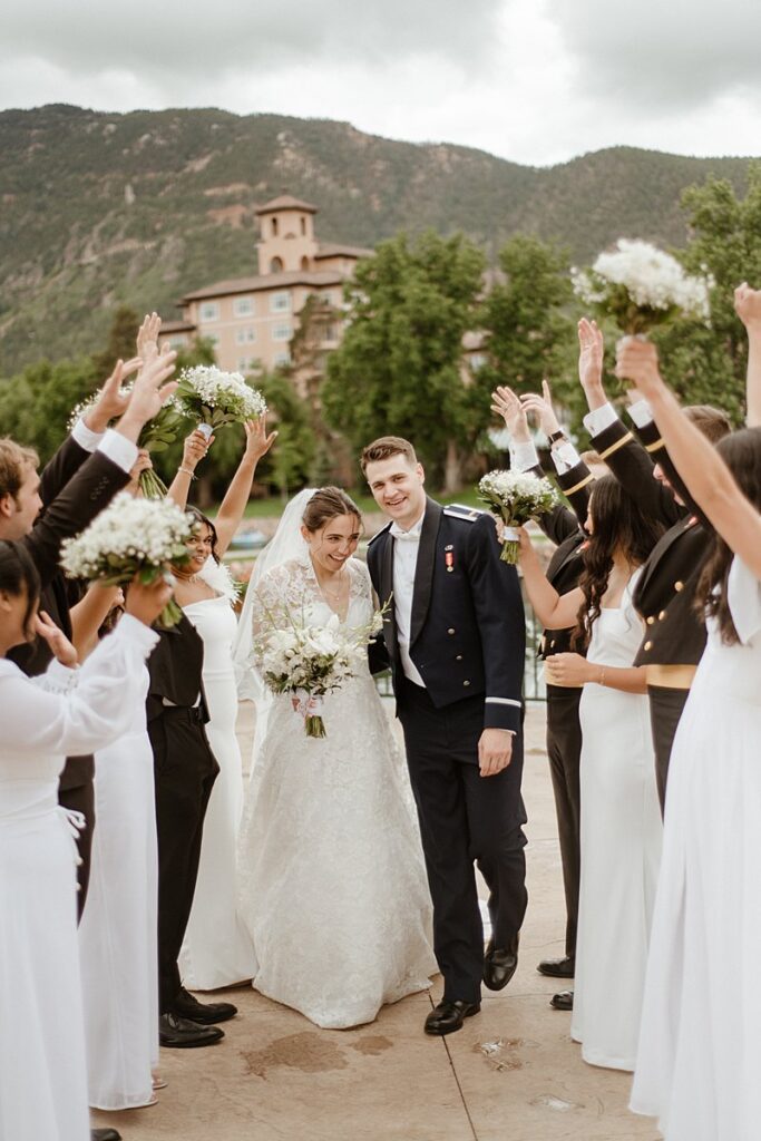 a wedding party celebrating by the lake at the Broadmoor