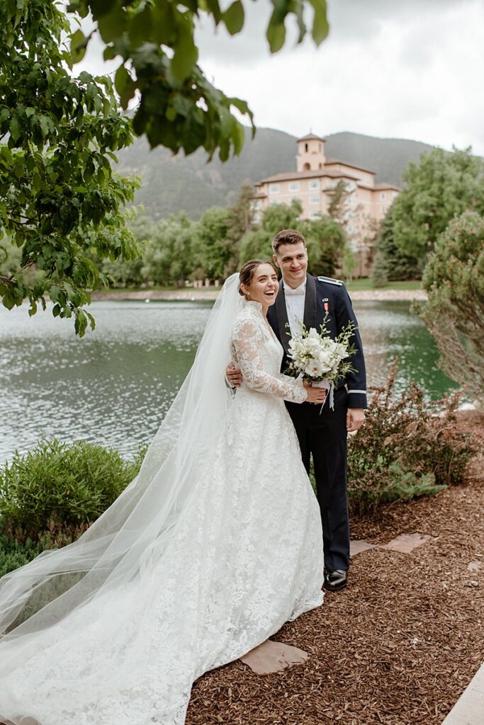 a wedding couple celebrating by the lake at the Broadmoor