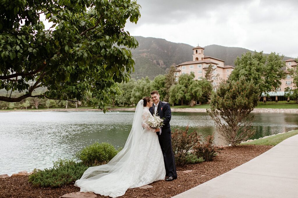 a wedding couple celebrating by the lake at the Broadmoor
