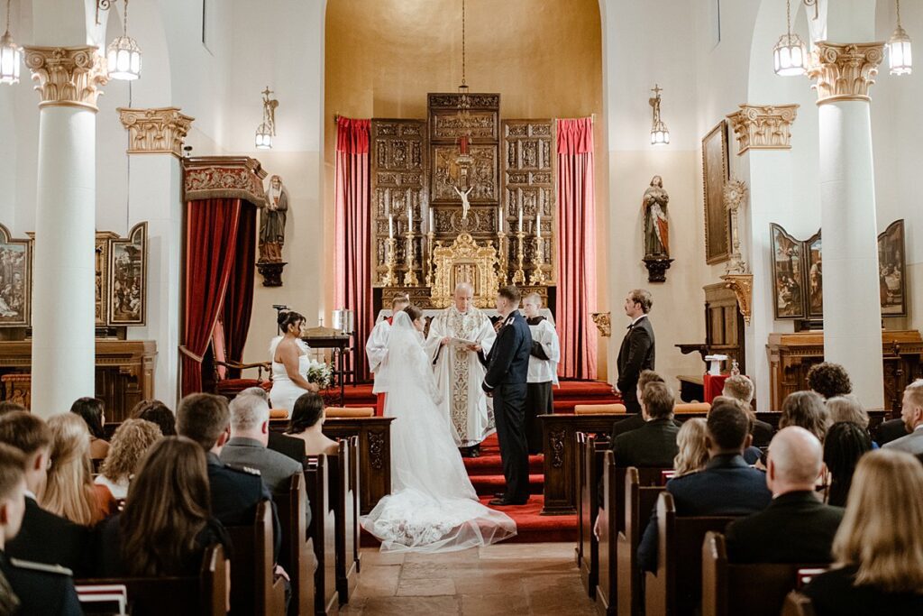 a traditional wedding ceremony inside of the Pauline Chapel at the Broadmoor in Colorado Springs
