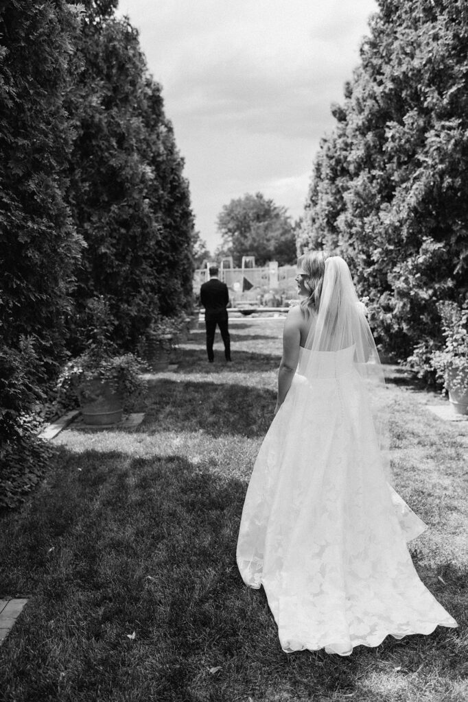 a bride walks up behind a groom at the Denver Botanic Gardens
