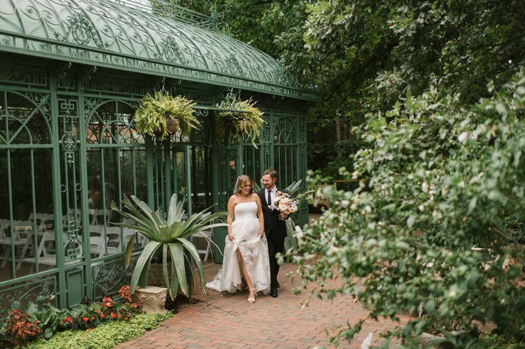 a bride and groom walk around the Denver Botanic Gardens during their Annuals Garden and Pavilion wedding 