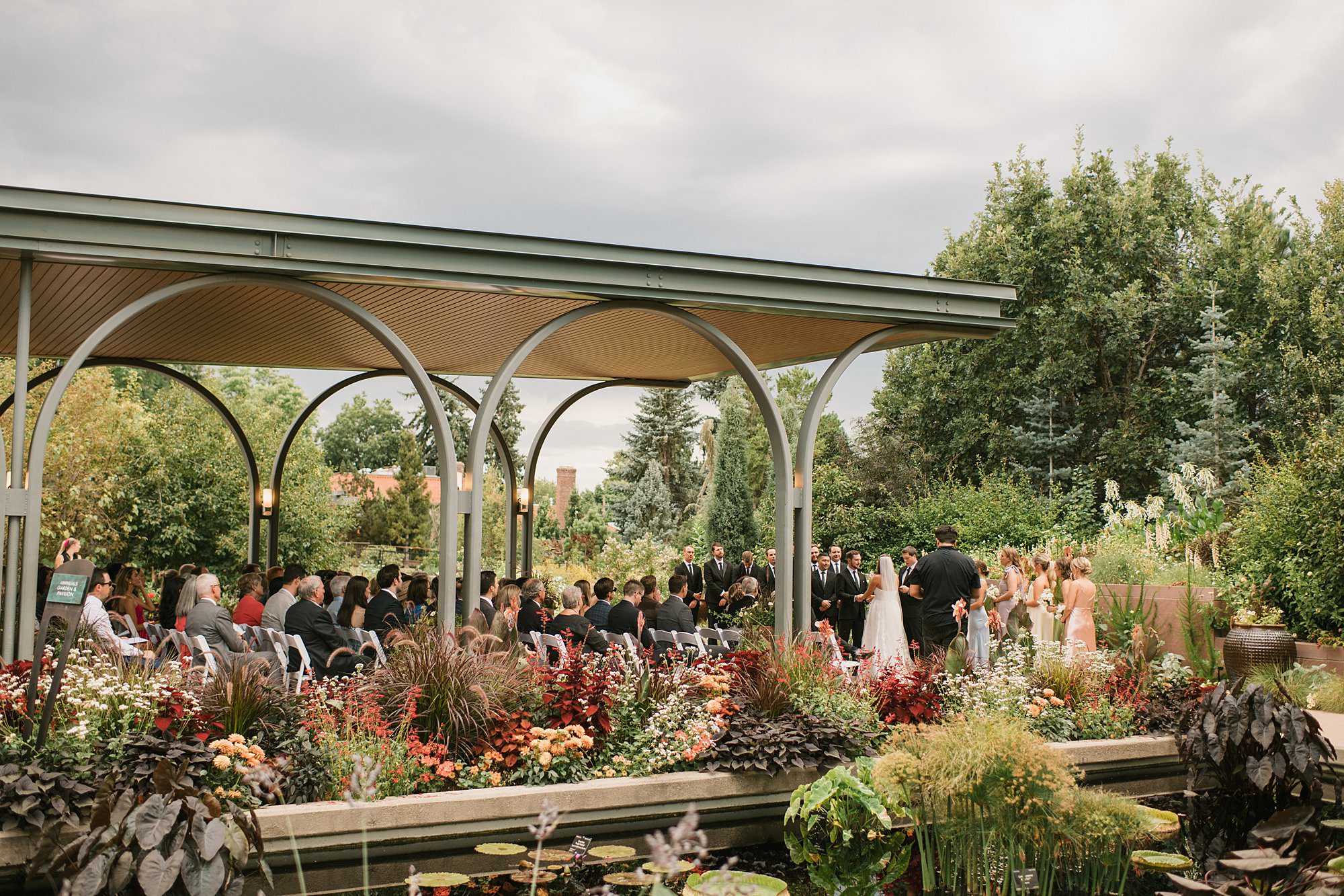A ceremony with pastels and spring flowers and the annuals garden and pavilion at the Denver Botanic Gardens in Denver, Colorado
