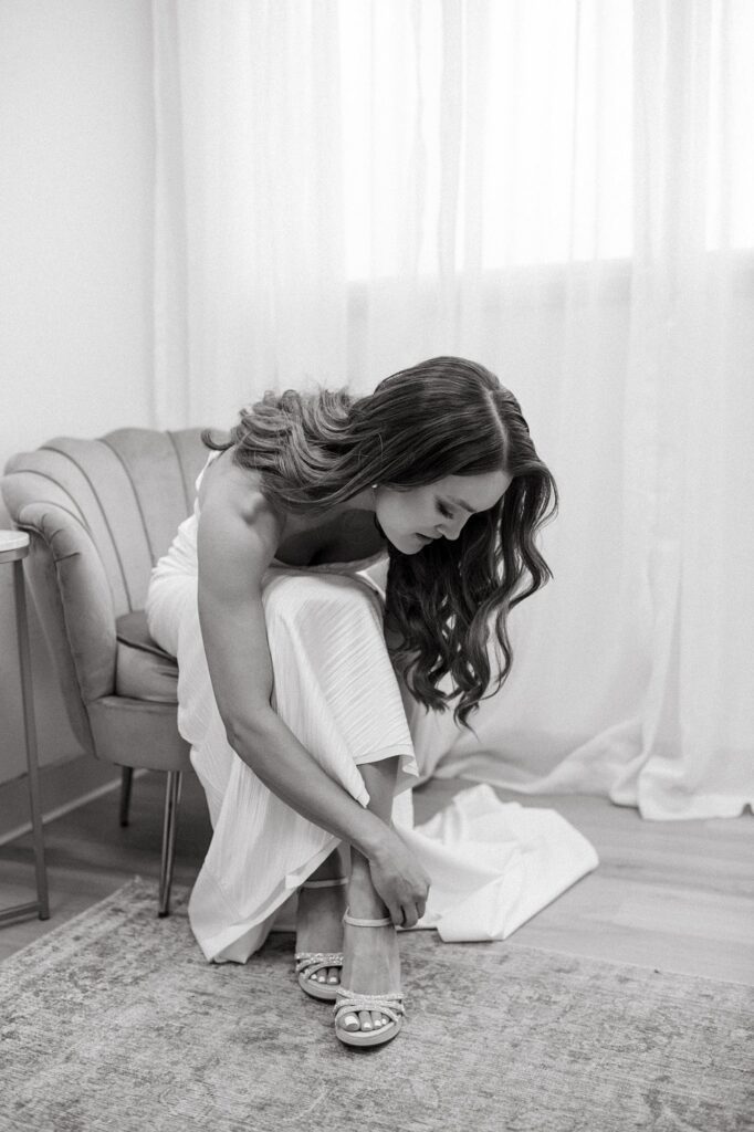 a bride getting ready and putting her shoes on before her Arrowhead Golf Course wedding