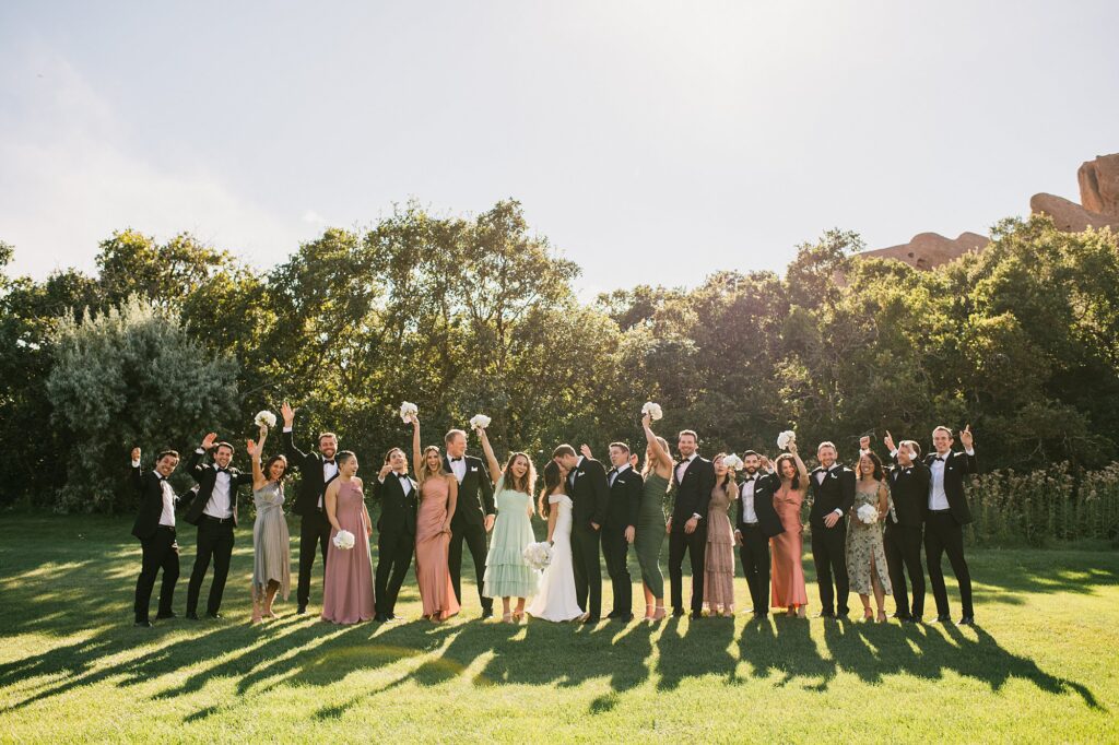 an entire wedding party celebrates on the green before a Arrowhead Golf Course wedding