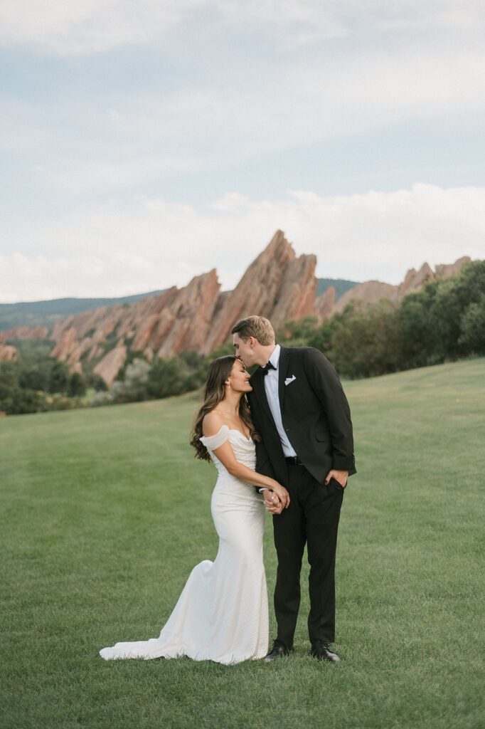 a bride and groom on the green before their Arrowhead Golf Course wedding