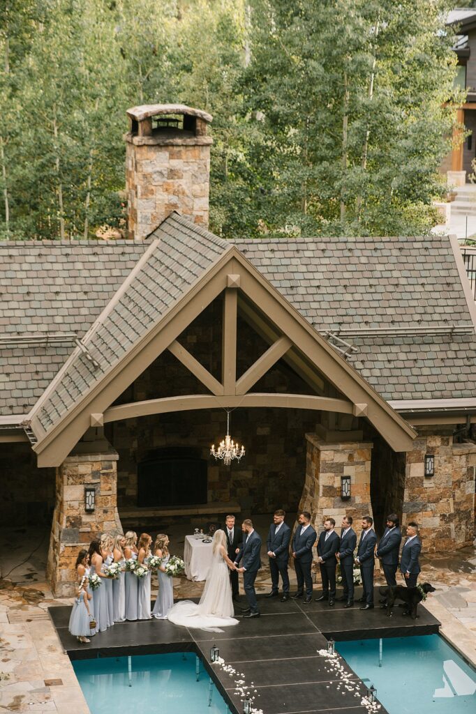 a wedding ceremony taking place over the pool during a Four Seasons Vail wedding