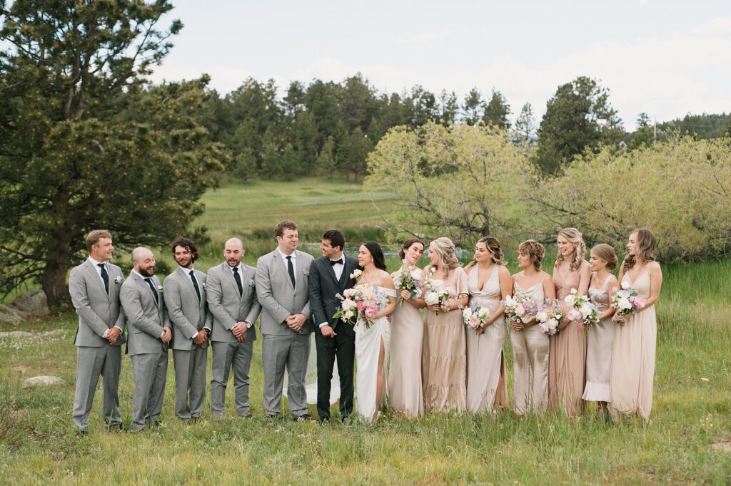 a wedding party in the fields of the Greystone Castle in Boulder, Colorado