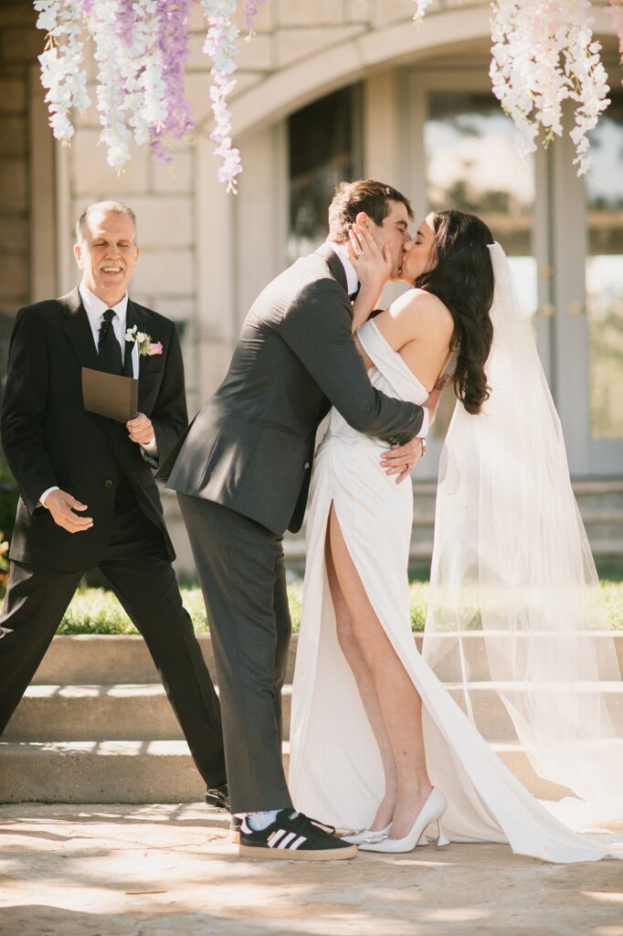 a bride and groom have their first kiss during their Greystone Castle wedding ceremony
