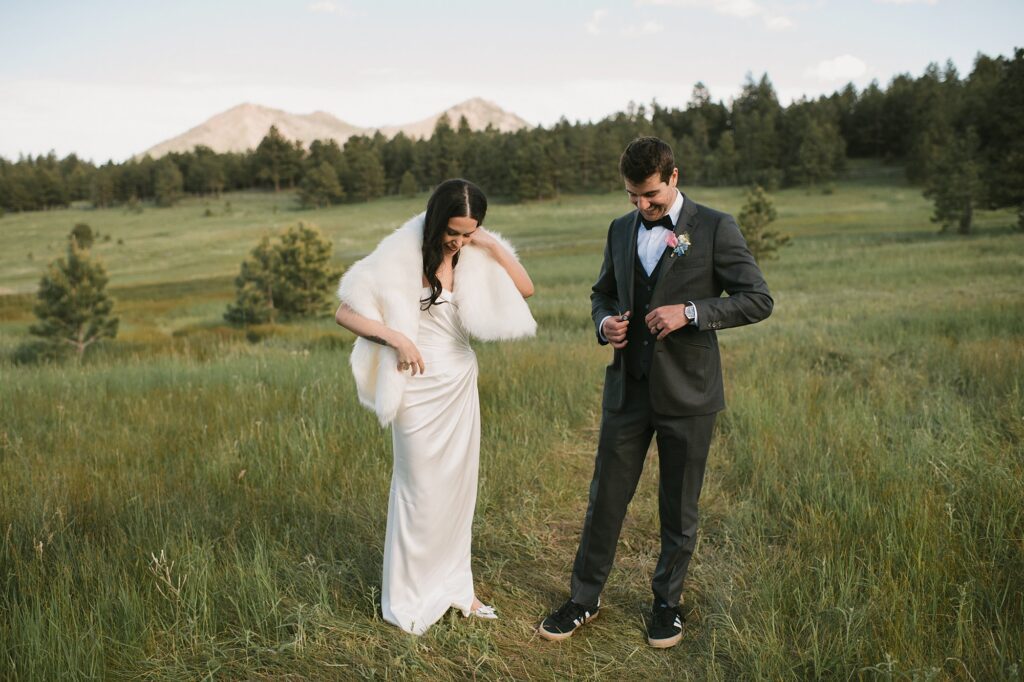 a bride and groom take their portraits in the field at Greystone Castle