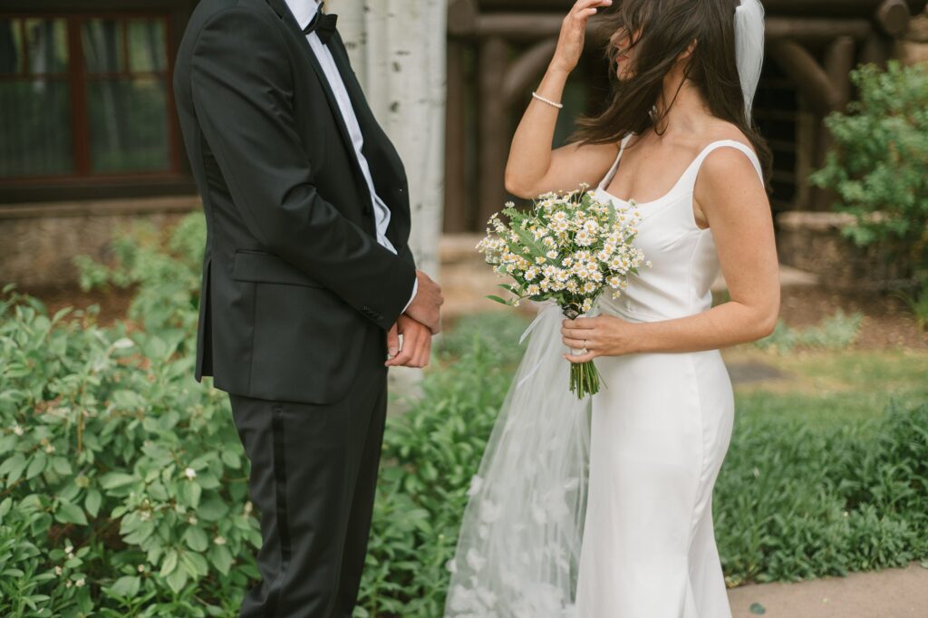 a bride and groom take some wedding portraits before their Beaver Creek intimate wedding ceremony at Julia's Deck