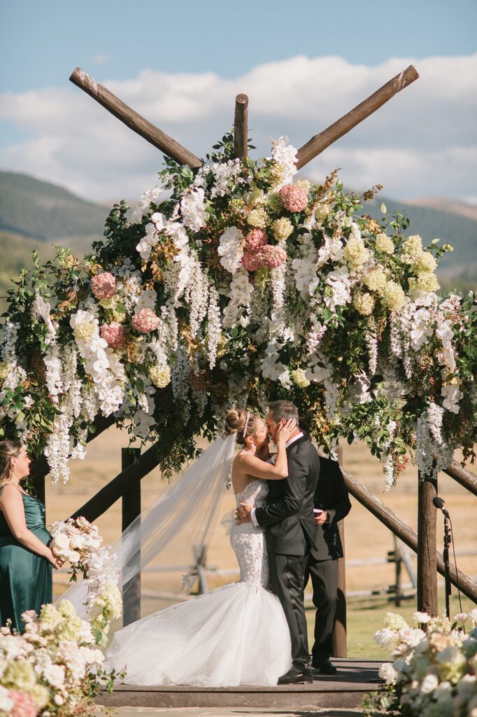 A devil's thumb ranch wedding ceremony set up with a lot of summer florals