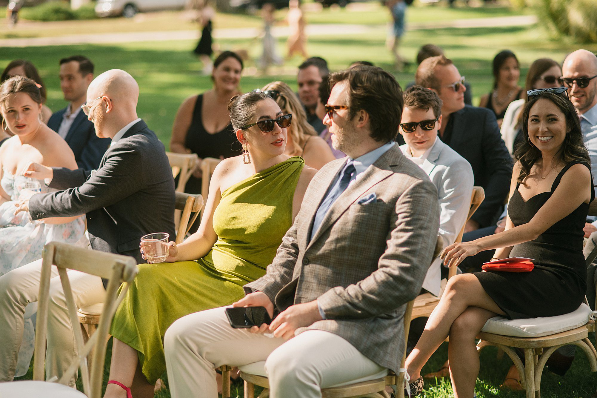 guests wait in the shade for their friends Washington Park Boathouse wedding in downtown Denver to begin