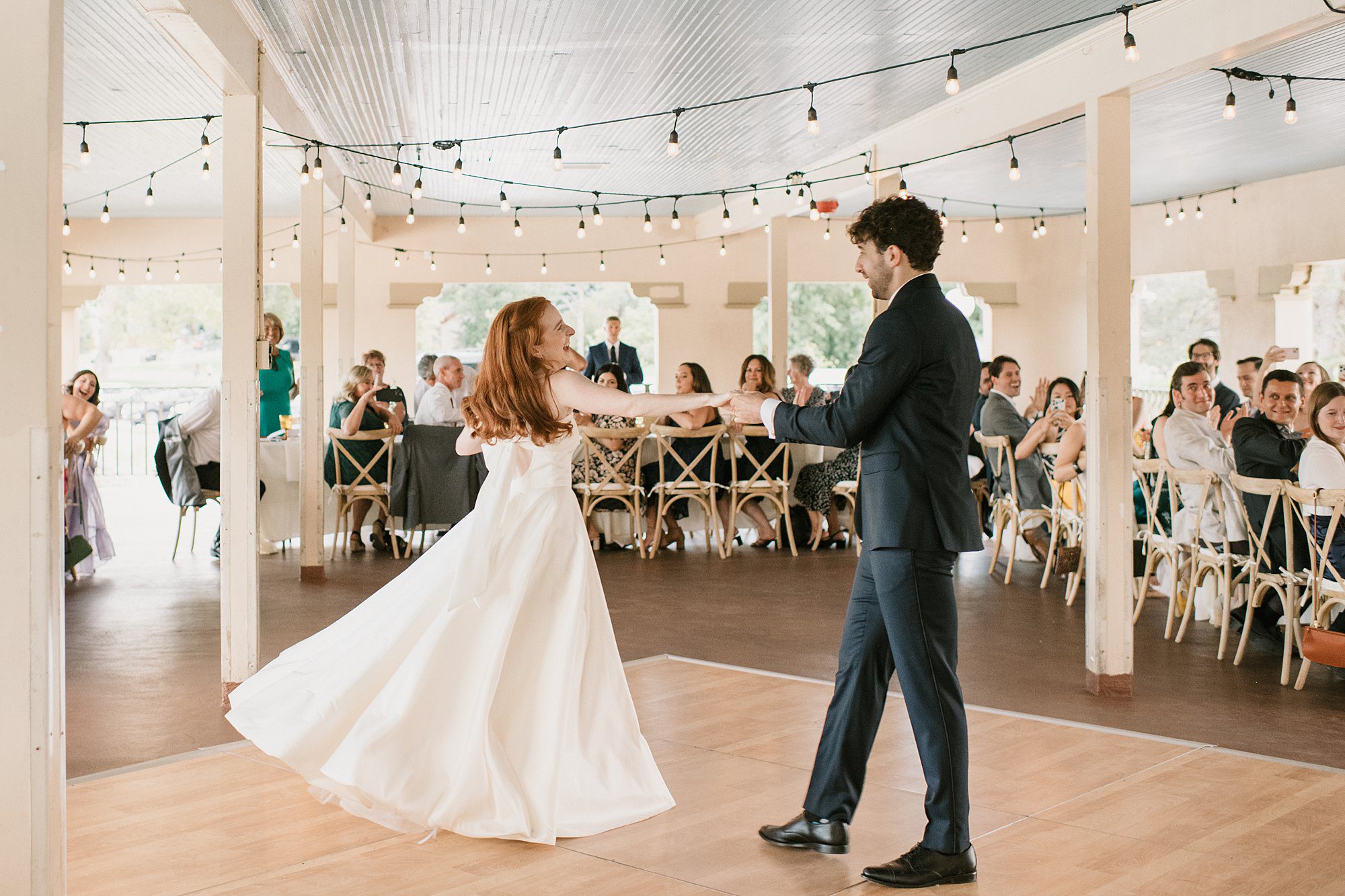 a bride and groom share their first dance during their Washington Park Boathouse wedding in downtown Denver