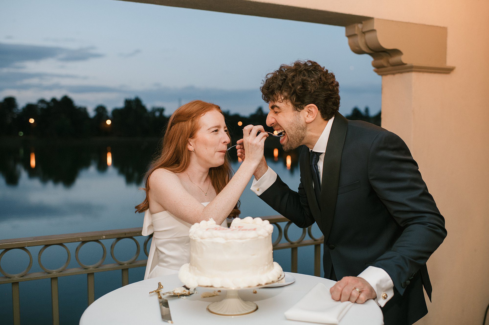 a couple cuts their cake during their Washington Park Boathouse wedding reception