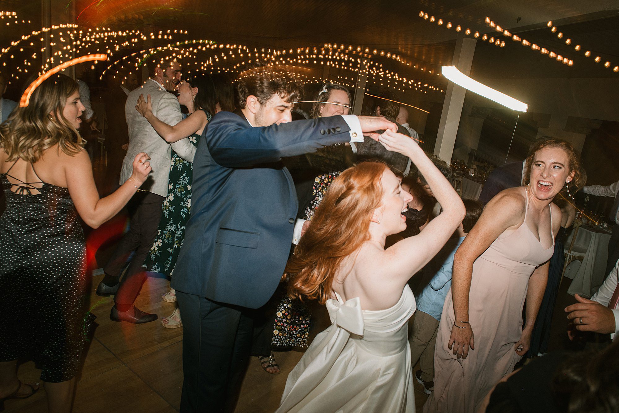a couples dances the night away on the dance floor of the Washington Park Boathouse