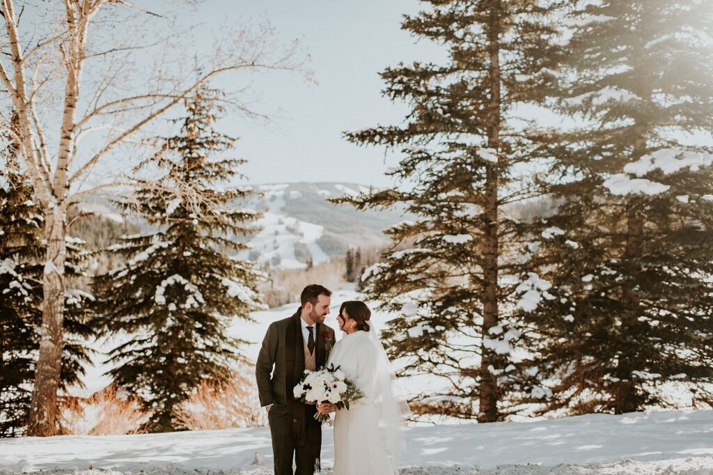 A bride and groom pose for their Colorado winter wedding
