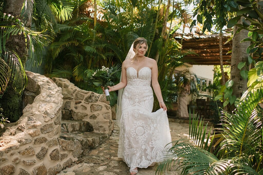 a bride walks through the jungle at this private island mexico wedding venue