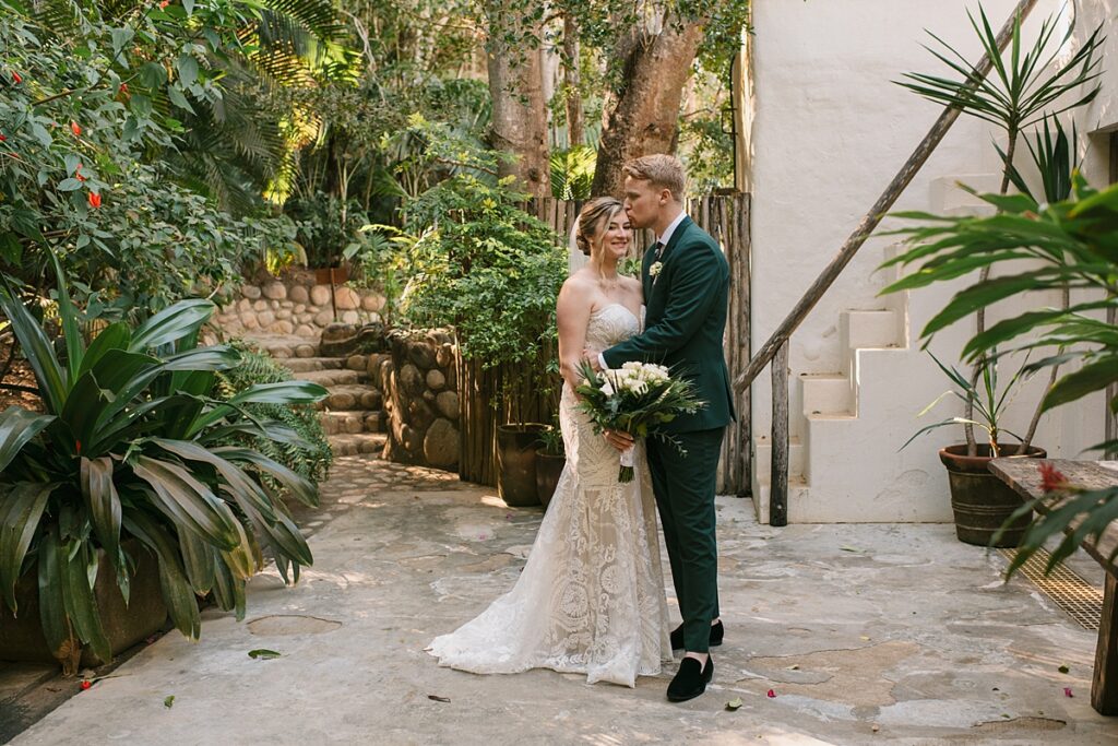 a bride and groom in the jungle of their private island mexico wedding venue