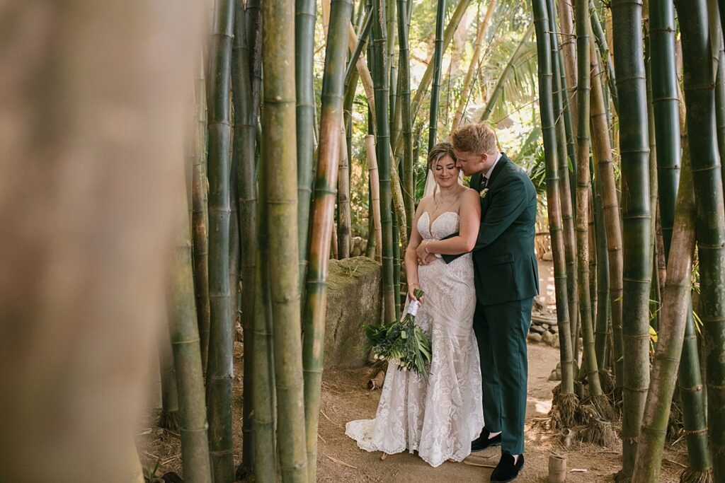 a bride and groom take portraits in a bamboo forest at a private island mexico wedding venue