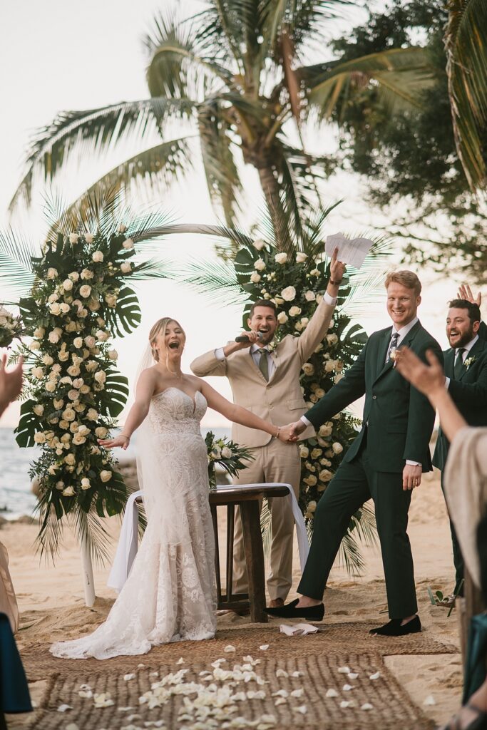 a bride and groom say "i do" at their private island mexico wedding venue