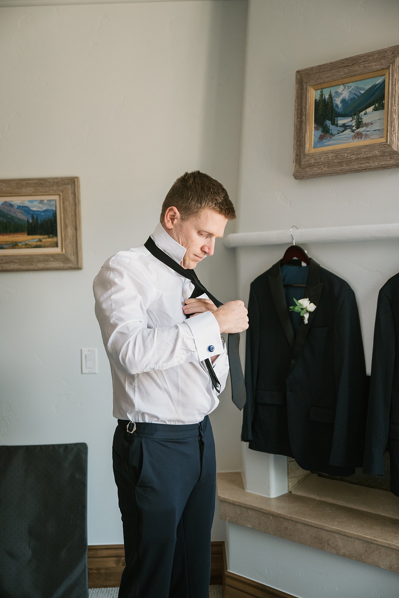 a groom gets dressed for his Arrabelle Square wedding