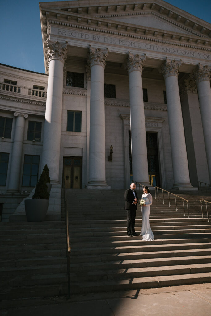 a Denver courthouse wedding with white columns and unique architecture