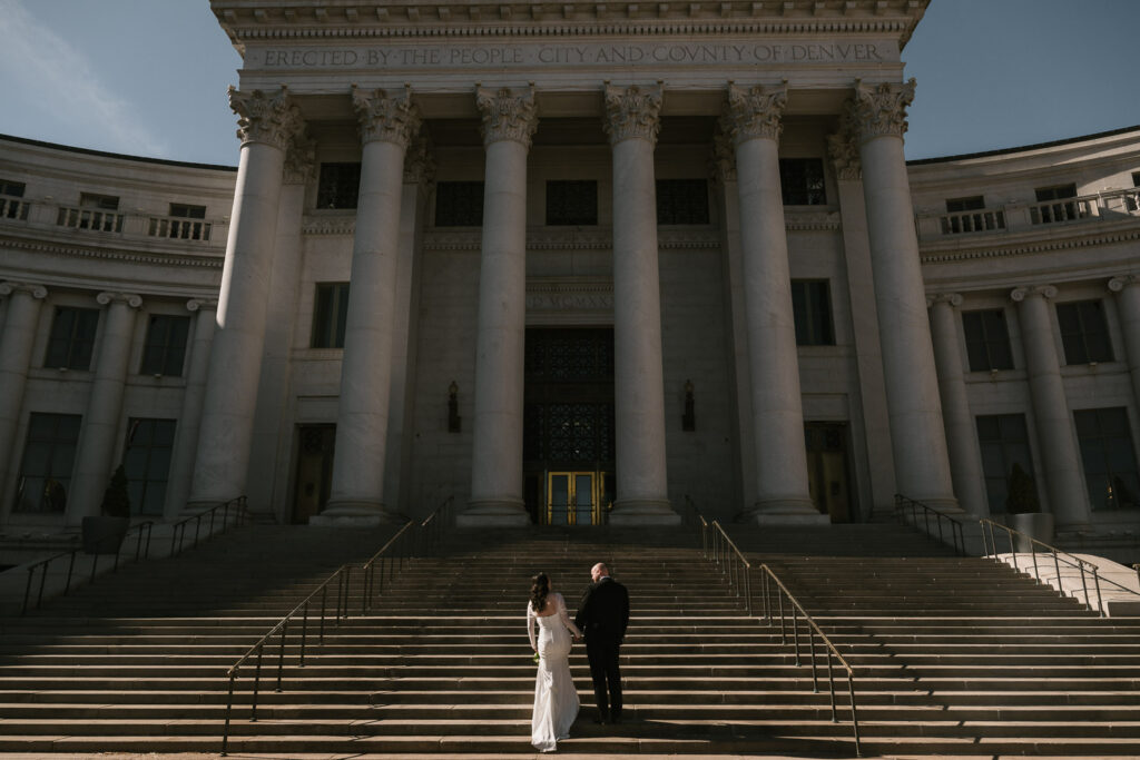a Denver courthouse wedding with white columns and unique architecture