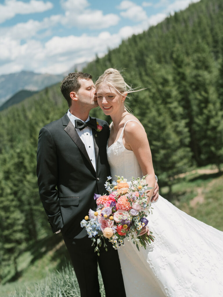 A Sonnenalp Hotel wedding in Vail with portraits of the bride and groom at the top of the ski mountain
