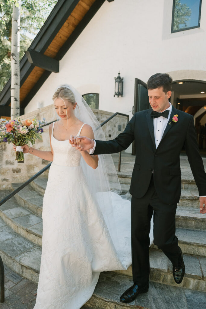 a couple walk down the aisle for their Sonnenalp Hotel wedding