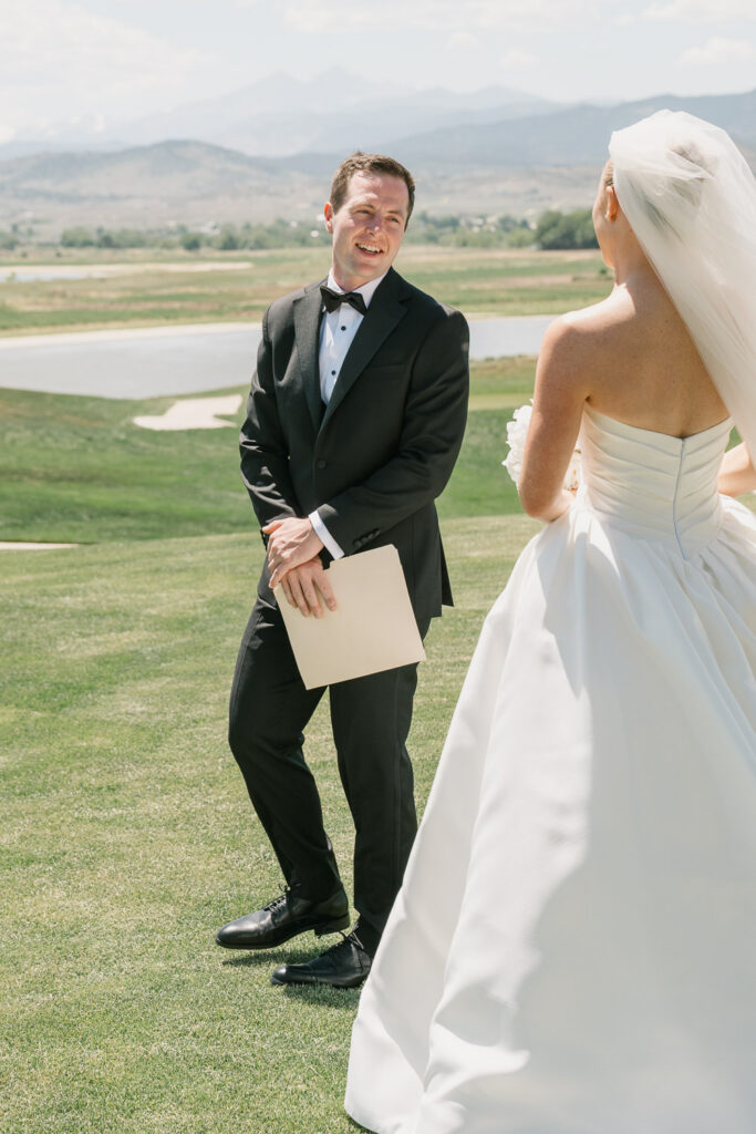 a groom sees his bride for the first time before their TPC Colorado wedding